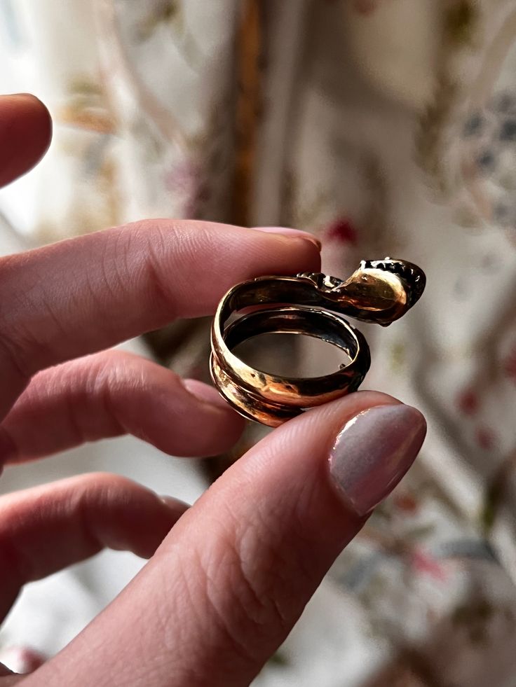 A sumptuous, incredible snake ring with blue, green, white, and red enamel, this outstanding ring is a fine example of the 1960's revival of Victorian art in jewelry. This specific ring takes the form of a gorgeous Victorian-esque snake with her open mouth, shining teeth, and inquisitive eyes, slithering up off of the finger to greet her wearer, or perhaps their conversation partner with her wide grin. This vintage example boasts a 14k yellow gold snake with many beautiful enameled details, and Antique Snake Ring As Gift, Formal Snake Ring With Polished Finish And Open Shape, Elegant Hallmarked Snake Ring, Polished Finish Open Snake Ring For Formal Occasions, Formal Polished Open Snake Ring, Formal Polished Finish Open Snake Ring, Unique Hallmarked Snake Ring For Formal Occasions, Unique Open Ring Snake Ring For Anniversary, Unique Open Snake Ring For Anniversary