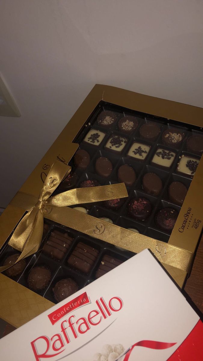 a box of chocolates with a gold ribbon around it and a package of bafffelo on the side