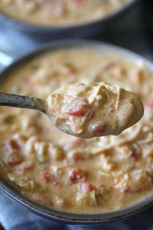 a spoon full of soup in a bowl