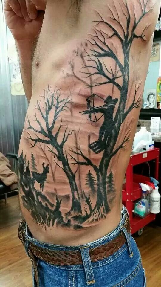 a man's back with trees and deers on it