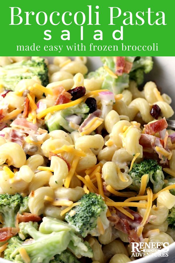 broccoli pasta salad made with frozen broccoli in a white bowl and topped with cheese