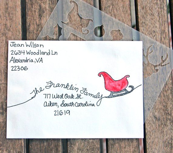 a piece of paper with a red bird on it sitting on top of a wooden table