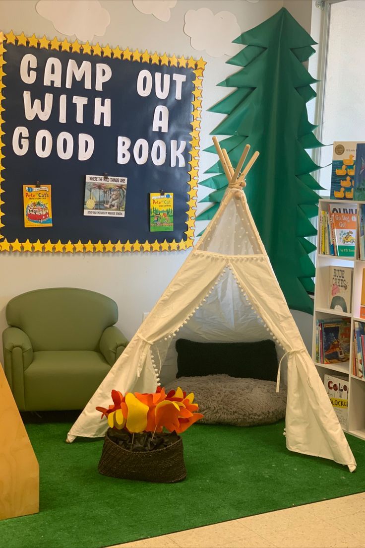 a teepee tent is set up in the corner of a room with green carpet