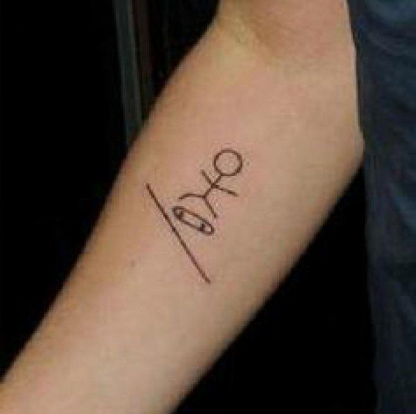 a person with a tattoo on their arm that says love and scissors in cursive writing