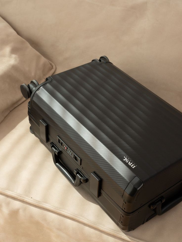 With the strength and durability to endure rough handling by baggage handlers, this rolling suitcase features a heavy-duty aluminum alloy hardshell exterior.Rubber seals, a zipperless closure, a one-push-to-open TSA combo lock, and ultra-smooth 360° spinner wheels ensure your belongings are secure and easy to carry whe Black Suitcase Aesthetic, Zipperless Luggage, Premium Luggage, Travel Tools, Luggage Bags Travel, Leather Luggage Tags, Leather Luggage, Carry On Luggage, Luggage Tag