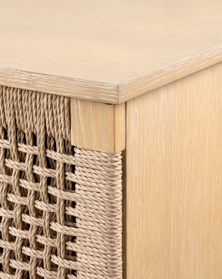 a close up view of a wooden table with wicker weave on the top and bottom