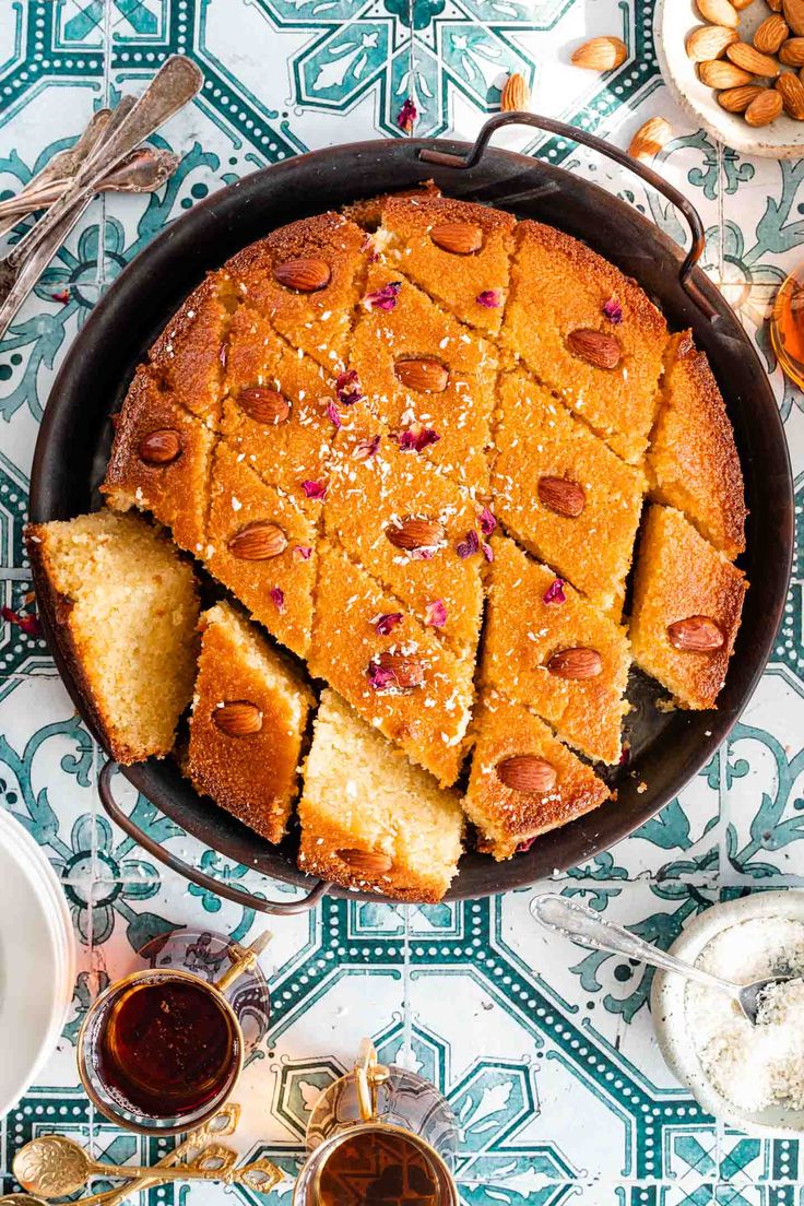 a pan filled with slices of cake on top of a blue and white table cloth