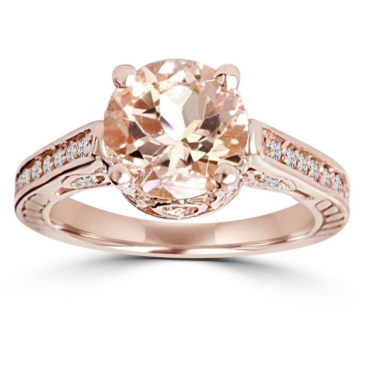 an oval cut engagement ring with diamonds on the band and side stones in rose gold