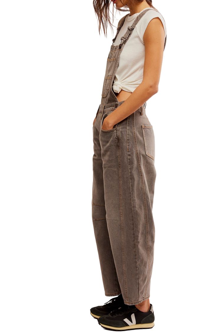 Revive a childhood favorite for your modern wardrobe with well-faded denim overalls cut for a generously roomy fit. 25" inseam; 19" leg opening (size Medium) Adjustable buckle straps; side button closures Square neck Bib pockets; front scoop pockets; coin pocket; back patch pockets 64% cotton, 36% lyocell Machine wash, tumble dry Made in Turkey Overalls Styling, Linen Dungarees, Overalls Flare, Free People Overalls, Cute Overalls, Scarf Top, Skirt Jumpsuit, Faded Denim, Modern Wardrobe