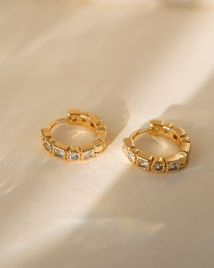 Add a touch of charm and sophistication to your jewelry collection with our Rae Geometric Huggies! Featuring sparkling cubic zirconia and shimmering gold, these earrings are perfect for adding a touch of elegance to any outfit. Elevate your style and embrace your unique beauty with these stunning huggies! EARRINGS FEATURE Material: Brass, White Cubic Zirconia Size: 14mm Finish: 18K Gold Freshwater Pearls Earrings, Unique Beauty, Pretty Earrings, Moonstone Ring, Opal Necklace, Jewelry Packaging, Delicate Necklace, Silver Roses, Silver Rose Gold