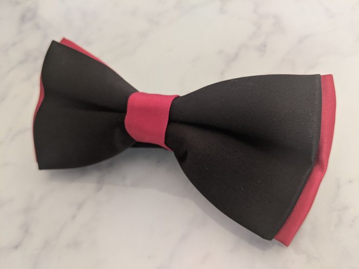 Upgrade your wardrobe in style with this stunning red on black satin bow tie. Perfect gift for him, this unique adjustable bow tie will elevate your style for any occasion including weddings, birthdays and anniversaries. Comes pre-tied. Fitted Red Bow Tie For Black Tie Events, Black Bow With Tie Back As Gift, Red Bow Tie For Formal Occasions, Red Bow Tie For Black Tie Occasions, Elegant Red Bow Tie For Party, Red Formal Suit And Bow Tie Accessories, Formal Black Bow Tie With Ribbon, Elegant Red Bow Tie For Formal Occasions, Black Adjustable Suit And Tie Accessories With Satin Bow