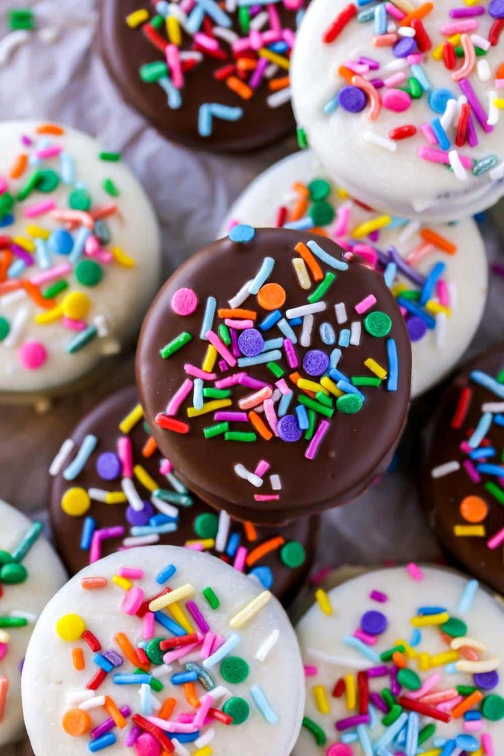 chocolate covered donuts with sprinkles and white frosting