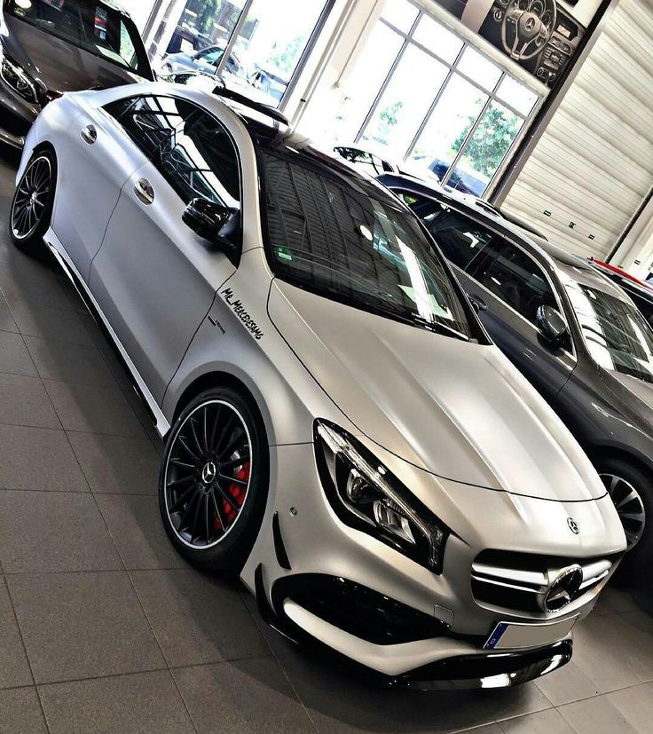 several mercedes cars are parked in a showroom