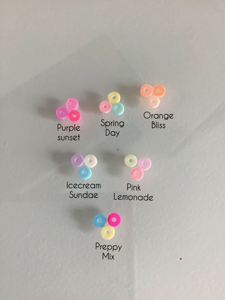 a bunch of different colored buttons on a white surface with the words spring, orange, pink, lemonade and prepay mix