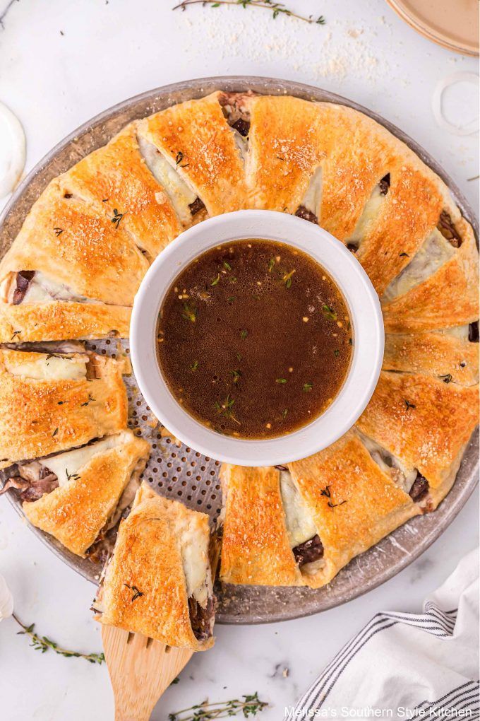 a plate with some food on it and a bowl of dipping sauce in the middle