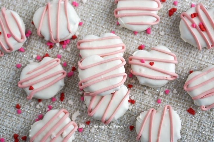 pink and white heart shaped cookies with sprinkles