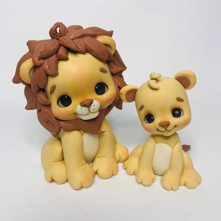 two little lion figurines sitting next to each other