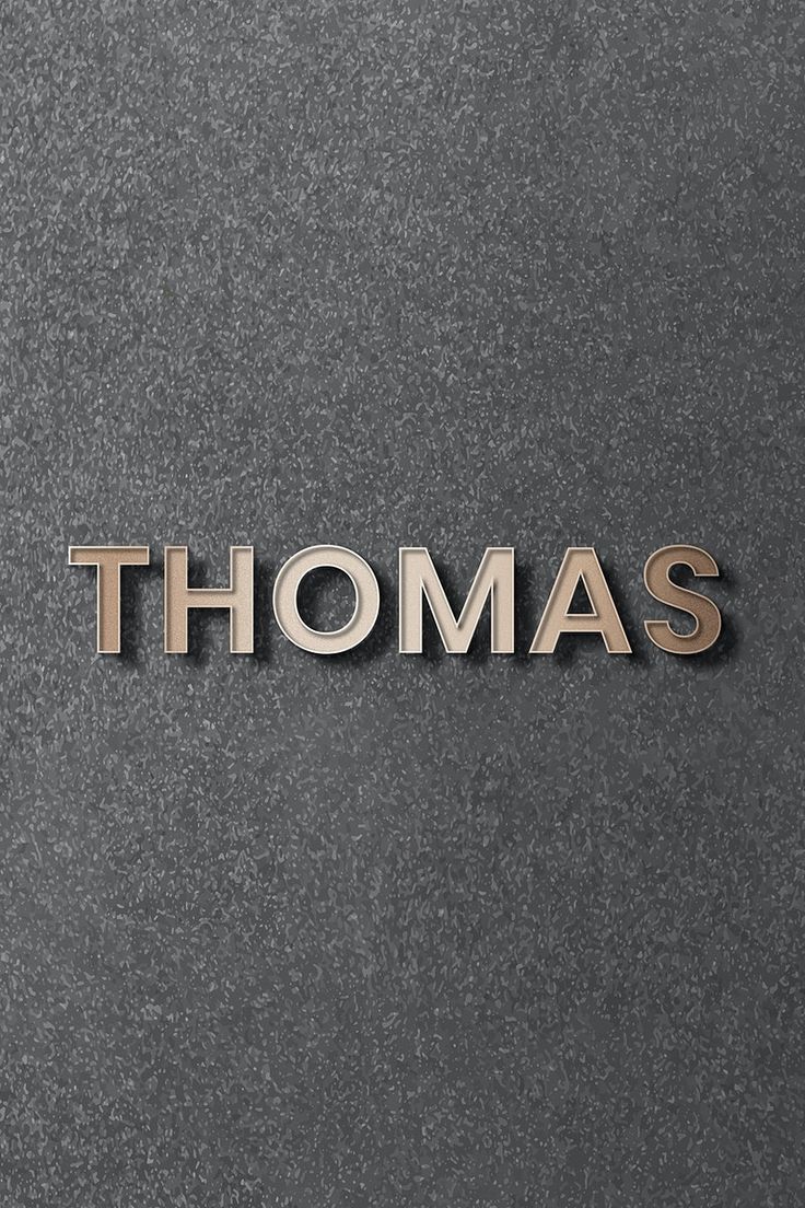 the word thomas written in metal letters on a black surface