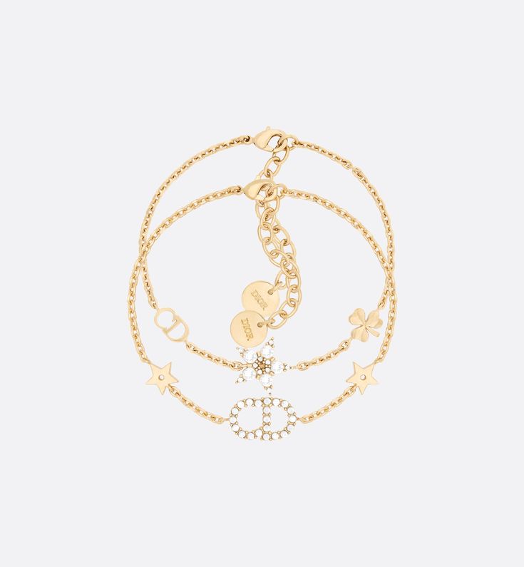 The Clair D Lune bracelet set is both elegant and delicate. The two gold-finish metal chain bracelets are accented with classic House symbols and sparkling crystals. The bracelet set can be worn separately or with other Clair D Lune creations.. Dior Gold, Elegant Jewellery, Gold Bracelet Set, Christian Dior Couture, Dior Jewelry, Chain Bracelets, White Crystals, Expensive Jewelry, Jewelry Essentials