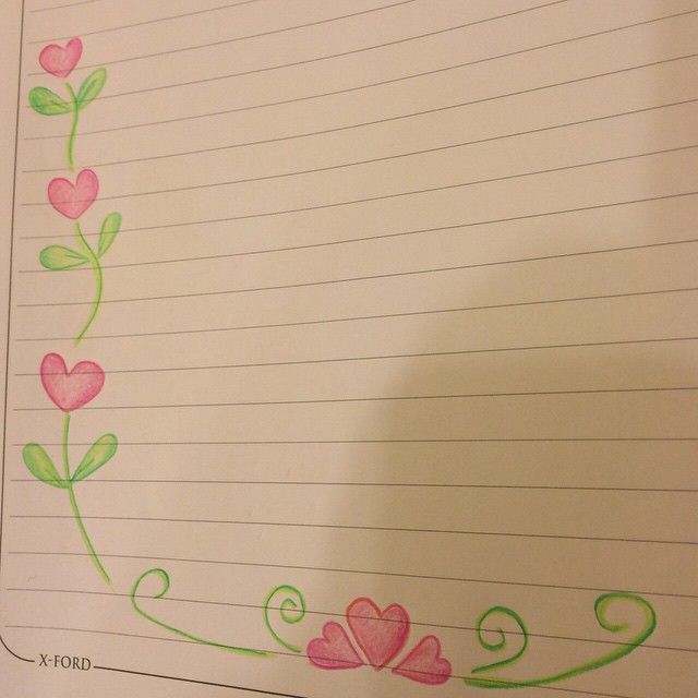 a piece of lined paper with flowers and hearts drawn on it, next to a pen