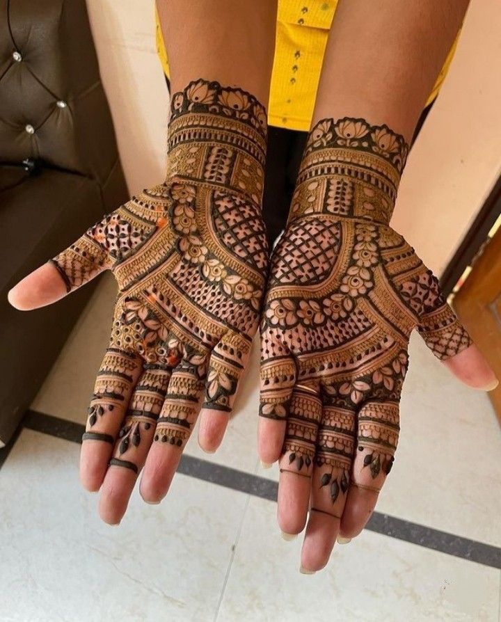 a woman's hands with hennap on it, showing the intricate design