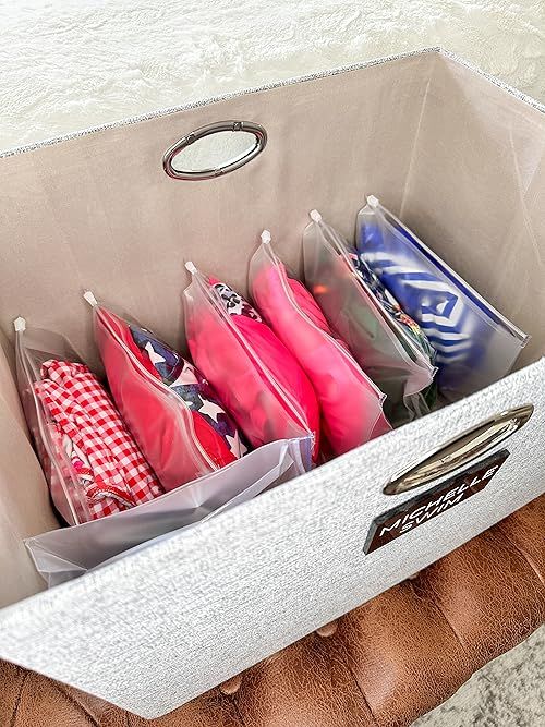 an open shoe box filled with umbrellas on top of a table