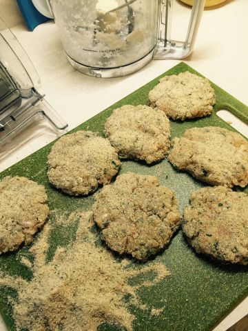 several cookies are on a green cutting board next to a blender and other items