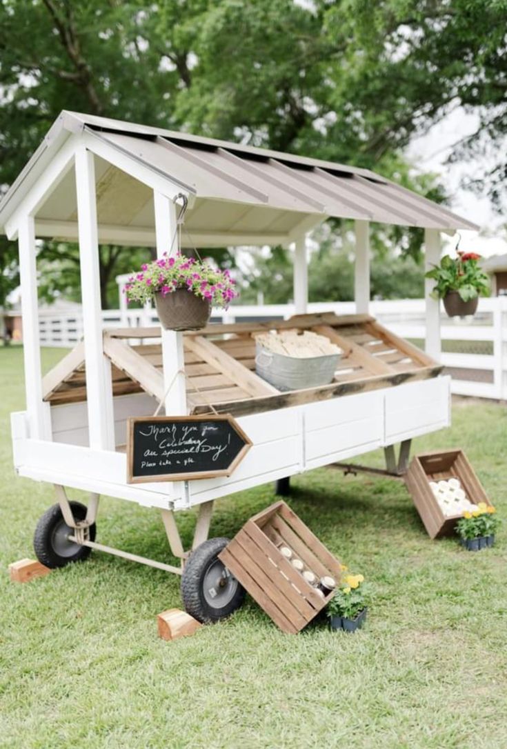 a small white cart with flowers on it