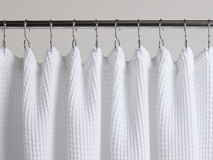 white curtains hanging on a metal rod