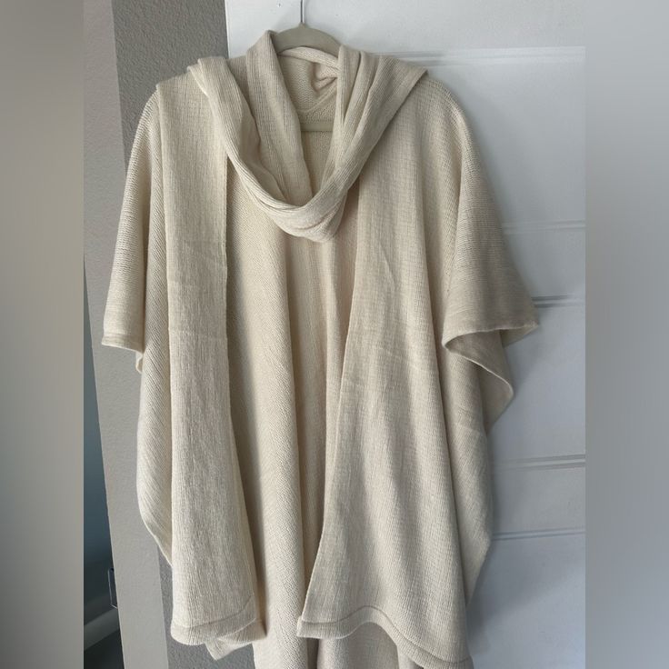 This Off-White Women’s Wrap/Poncho Style Sweater Will Be Cute To Add To Your Wardrobe. Cream Casual Poncho, One Size Fits All, Cream Casual Poncho One Size, Casual White Poncho With Batwing Sleeves, Casual White Cotton Poncho, Oversized White Poncho Cape, Oversized White Cape Poncho, White Oversized Casual Poncho, Casual Oversized Cream Poncho, Casual White Cape For Fall