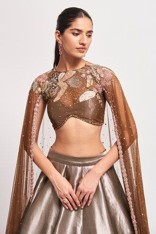 Copper and metallic two tone lehenga with abstract floral embellishments using varied metallic trims, sequins, beads and cutdana work. Paired with a blouse with a sheer yoke and floral embellishments. Comes along with a cape with geometric, floral embellishments using sequins, beads and cutdana work. - Aza Fashions Fitted Top With Sheer Dupatta For Evening, Fitted Tops With Dupatta For Reception, Fitted Wedding Tops With Dupatta, Fitted Wedding Top With Dupatta, Festive Party Tops With Sheer Dupatta, Fitted Party Top With Sheer Dupatta, Festive Organza Tops, Festive Organza Sets With Sheer Sleeves, Festive Sets With Sheer Sleeves And Organza Material