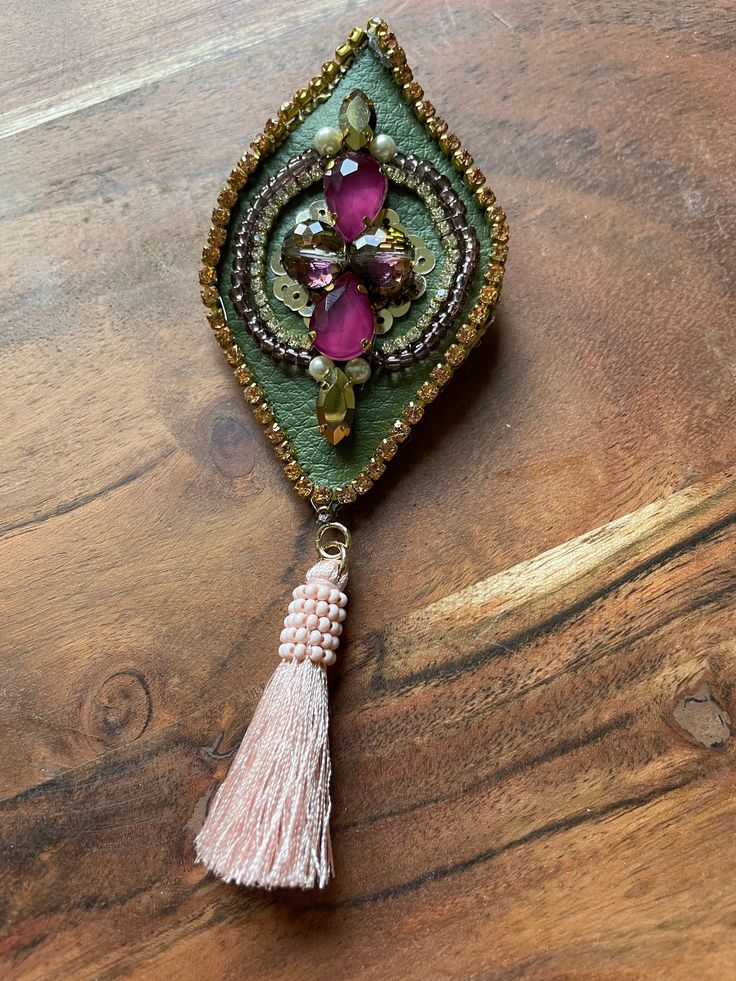 Beautiful colorful brooch, with crystals , rhinestones and a cute tassel. Bohemian Beaded Brooch For Party, Bohemian Beaded Brooches For Parties, Handmade Luxury Victorian Brooches, Sunstone Earrings, Unique Multicolor Multi-stone Brooches, Luxury Elegant Beaded Brooches, Luxury Statement Beaded Brooches, Luxury Ornate Gemstone Brooches, Multi Gemstone Necklace