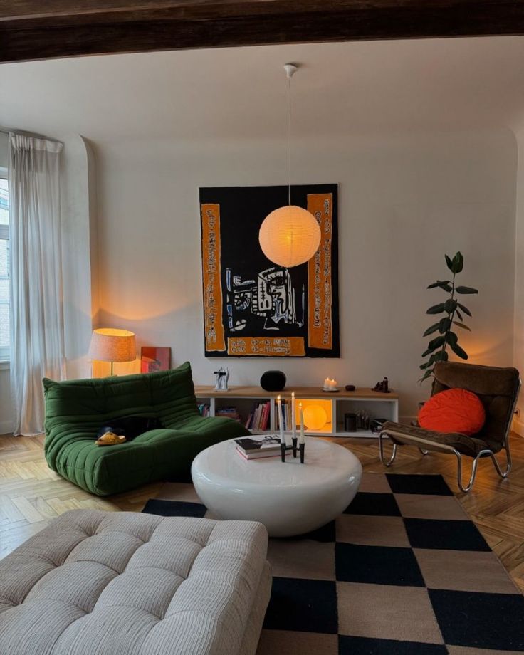 a living room filled with furniture and a painting on the wall