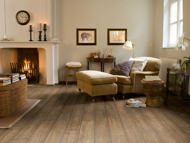 a living room filled with furniture and a fire place next to a wall mounted clock