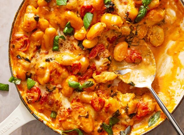 a skillet filled with pasta and vegetables