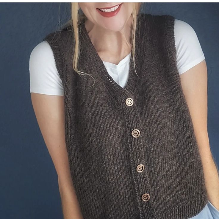 a woman wearing a brown knitted vest with buttons on the front and side, smiling