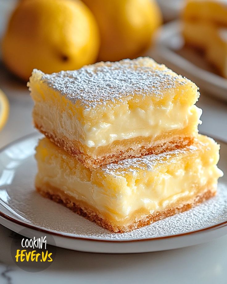 two pieces of cake on a plate with lemons in the backgroung