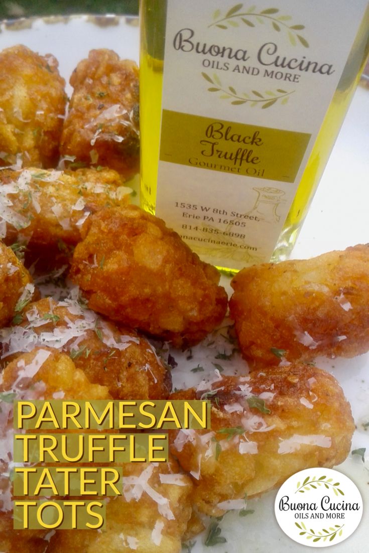 some fried food on a plate with a bottle of parmesan truffle tater tots