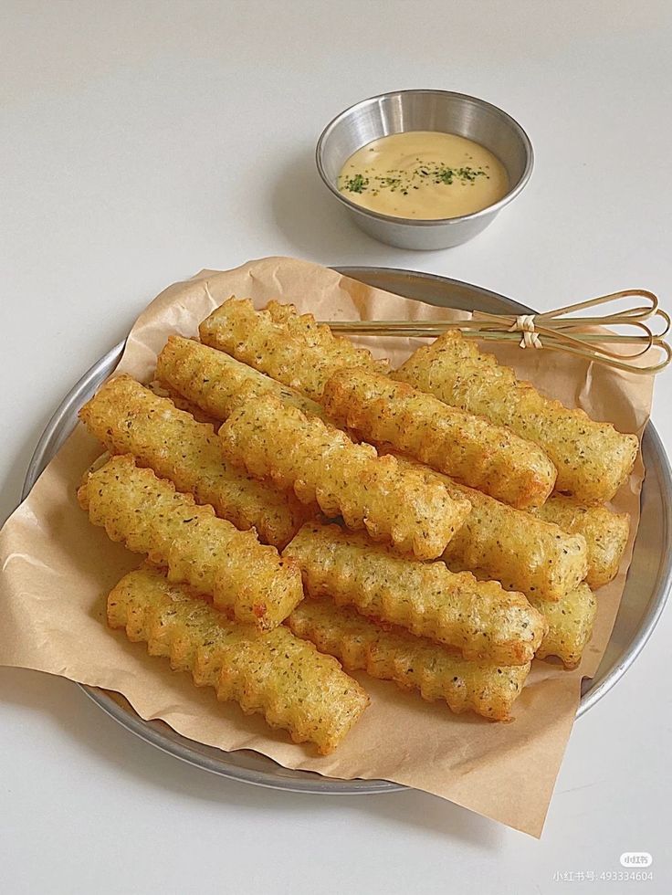 some fried food on a plate with dipping sauce