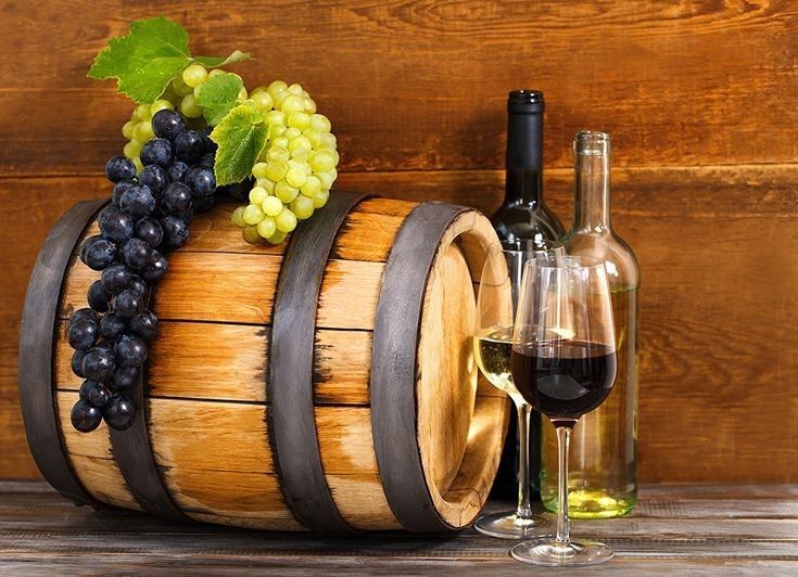 a wine barrel with some grapes on it