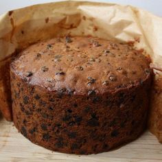 a chocolate cake sitting on top of a wooden cutting board