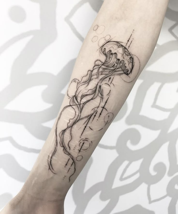 a woman's leg with a tattoo on it and a jellyfish in the water