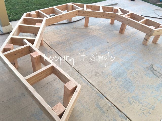 a wooden bench sitting on top of a cement floor