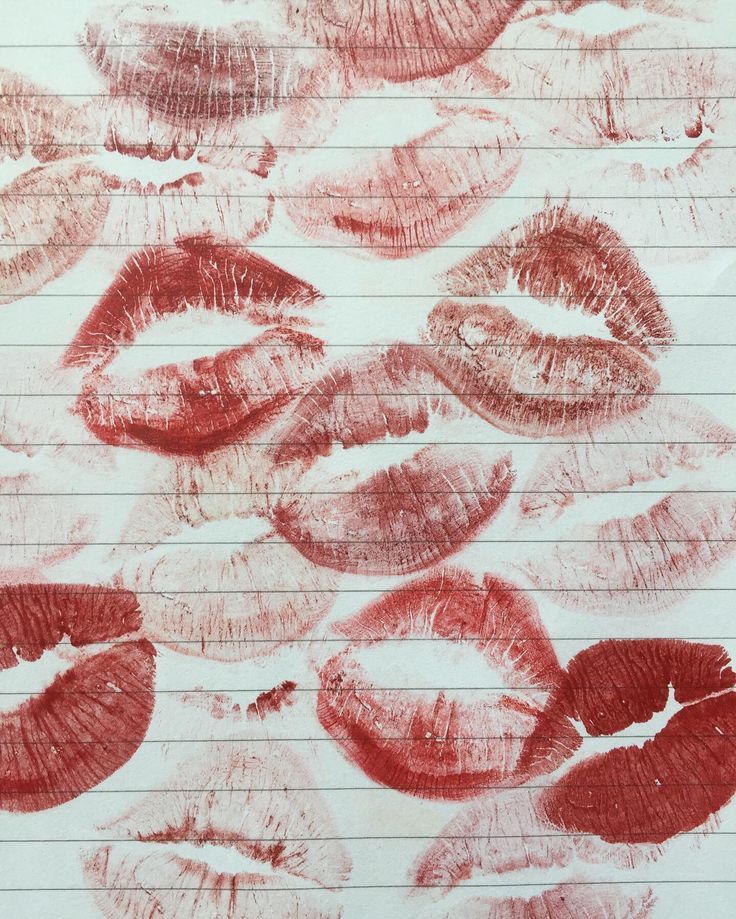 red lipstick drawn on lined paper with pencils in the shape of mouth shapes and lips