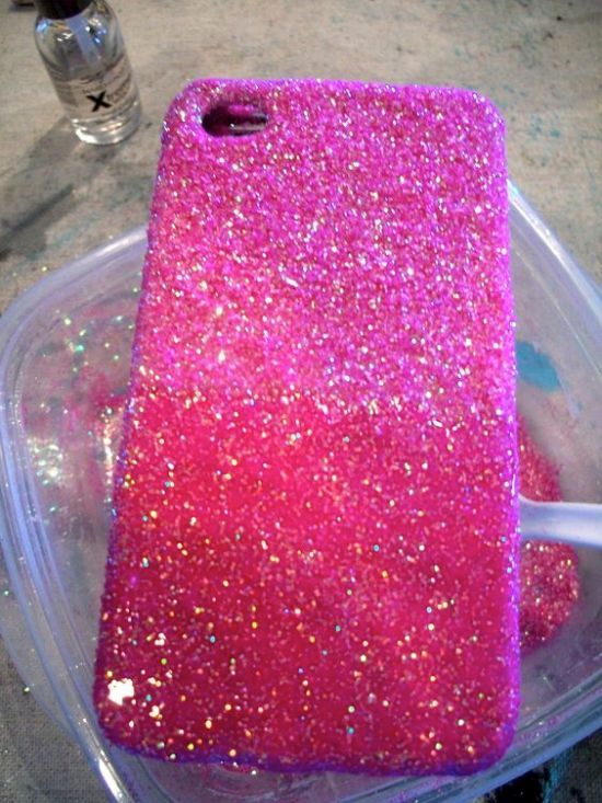 a pink phone case sitting on top of a plastic container