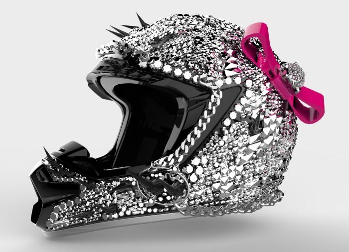 a helmet with spikes on the side and a pink ribbon tied to it's front