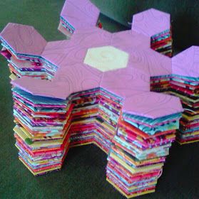 a large stack of folded papers sitting on top of a table