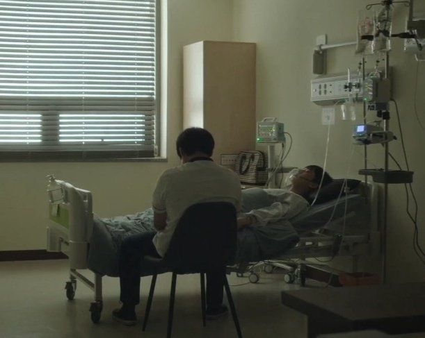 two people in a hospital room with medical equipment