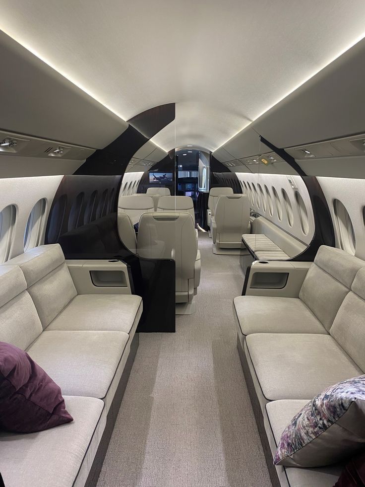 the inside of an airplane with couches and windows