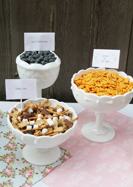 three bowls filled with cereal and marshmallows sitting on top of a table